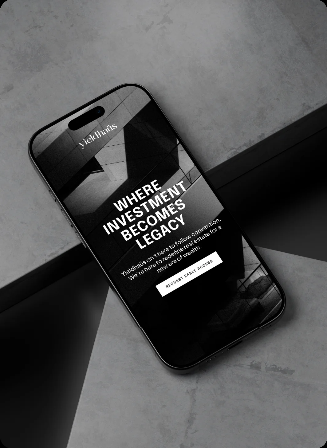 Phone on concrete showing “WHERE INVESTMENT BECOMES LEGACY” and a REQUEST EARLY ACCESS button