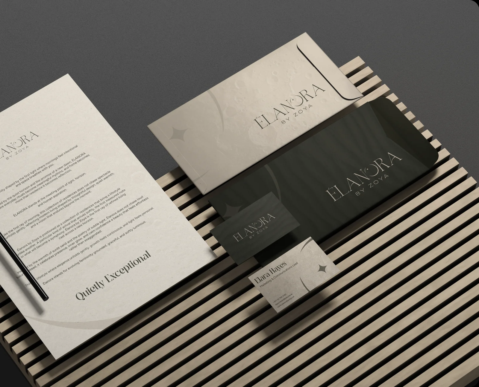 Élanora stationery on slatted wood: “Quietly Exceptional” letterhead, envelope and cards