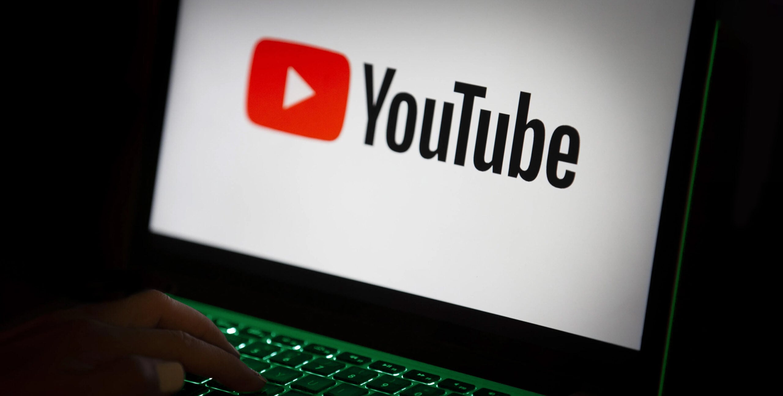 YouTube logo on laptop keyboard, video marketing for real estate brands