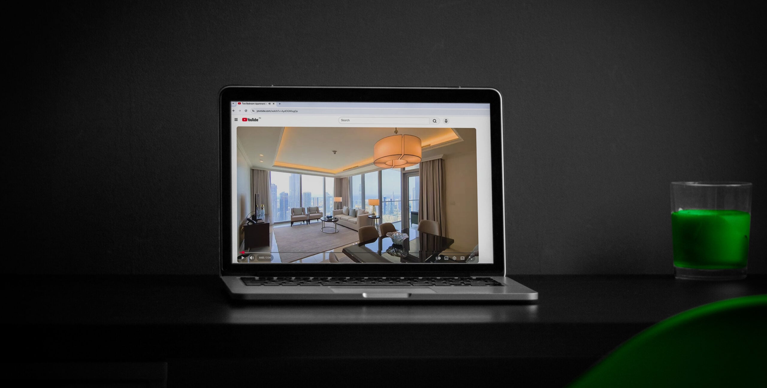 Laptop playing a YouTube property tour, real estate video marketing