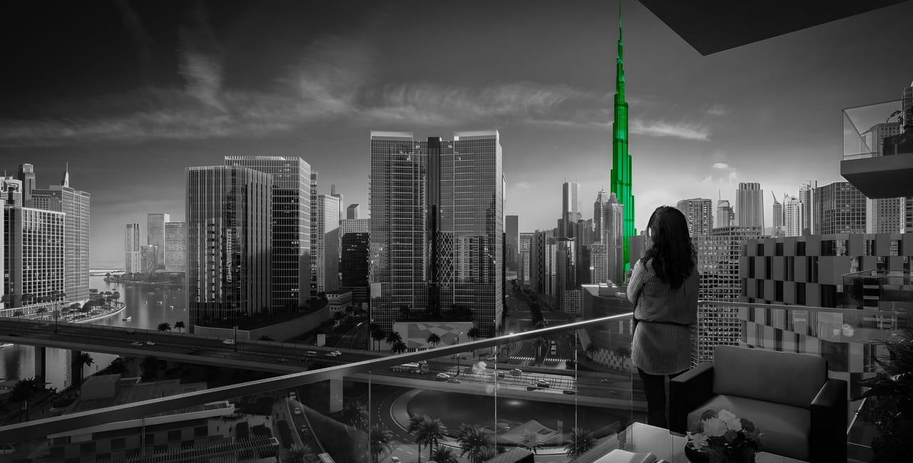 Woman on balcony overlooking Burj Khalifa, luxury real estate in Dubai