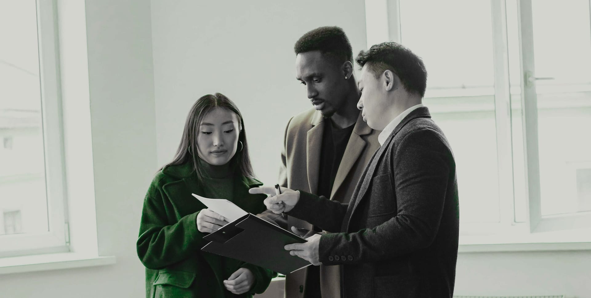 Real estate professionals reviewing a property document together