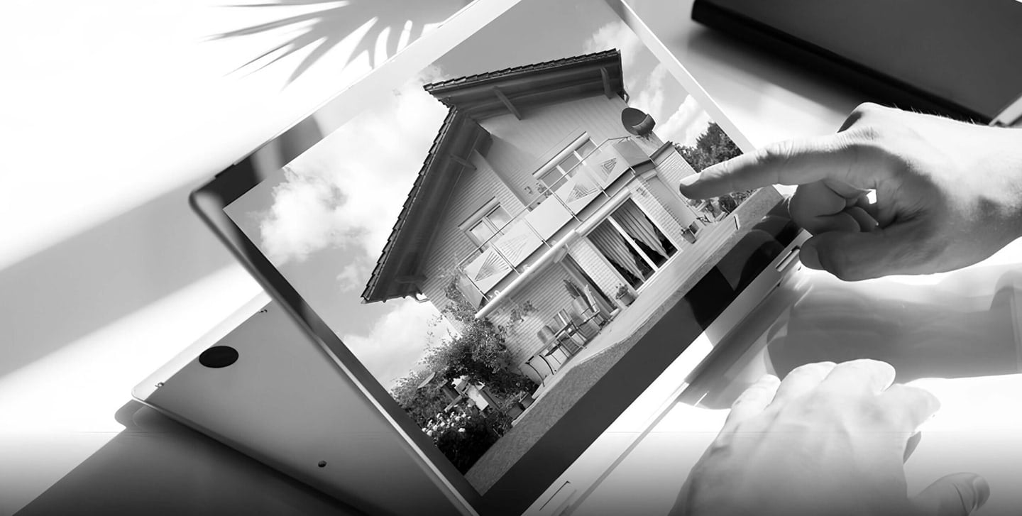 Hand pointing at a house photo on a tablet, property listing review