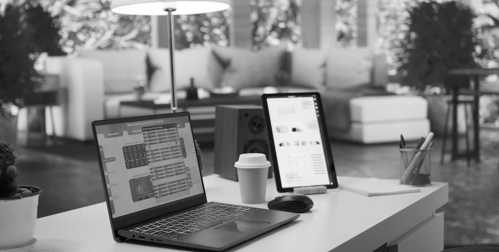Laptop and tablet showing investment dashboards, real estate market analytics