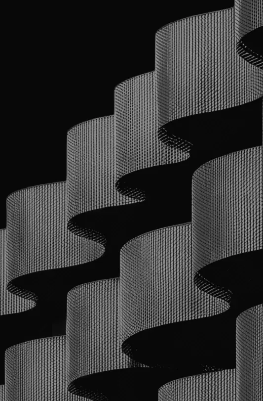 Wave-shaped balconies of a building facade in black and white