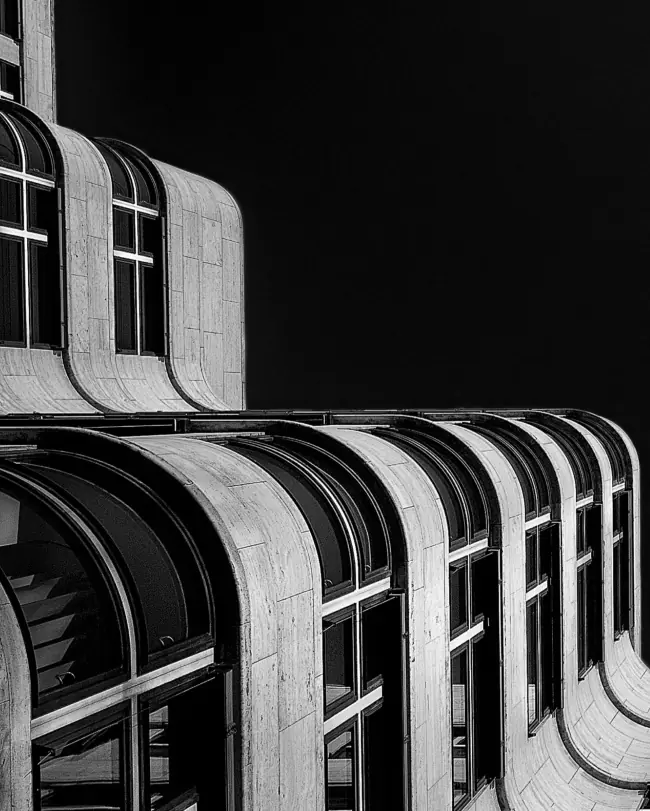 Curved facade of a modernist building in black and white